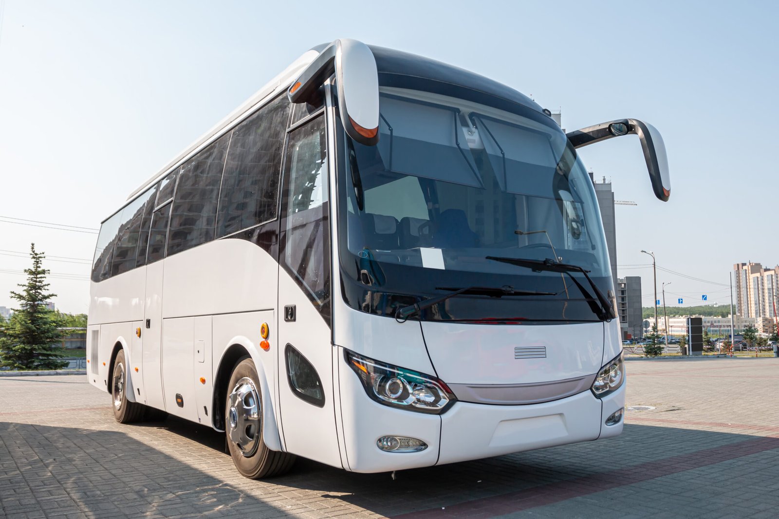 White intercity coach bus parked in a lot for professional bus charter service and group airport transfers