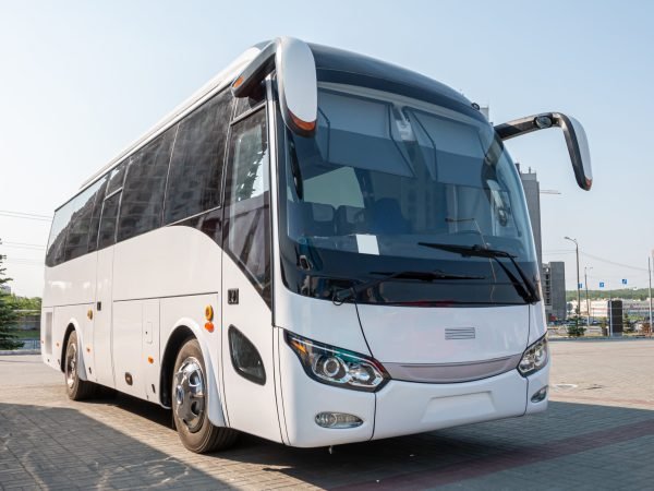 White intercity coach bus parked in a lot for professional bus charter service and group airport transfers